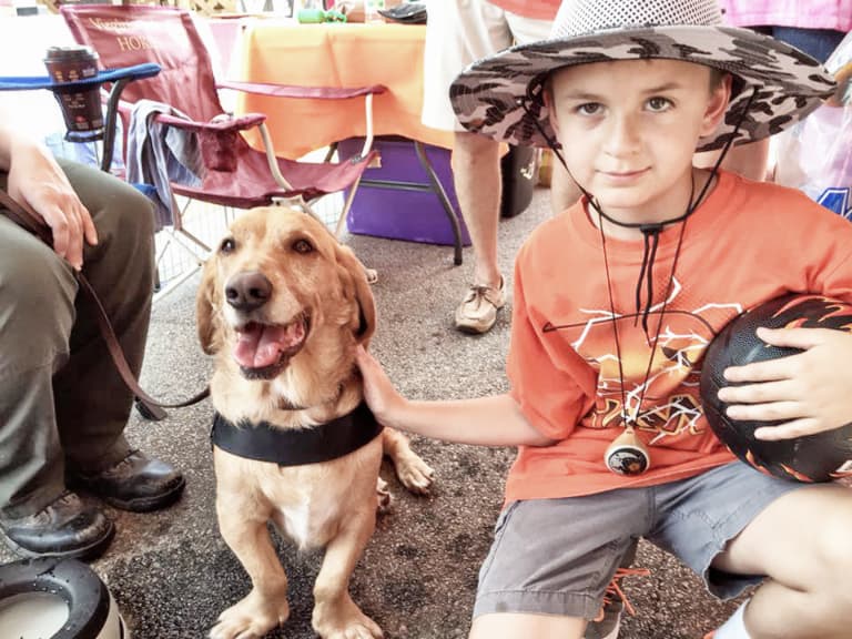 Child and team dog at community event